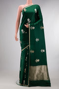 Pure Silk Bottle Green Banarasi Saree with Zari Butta on the body and Zari Border.  displayed on a mannequin