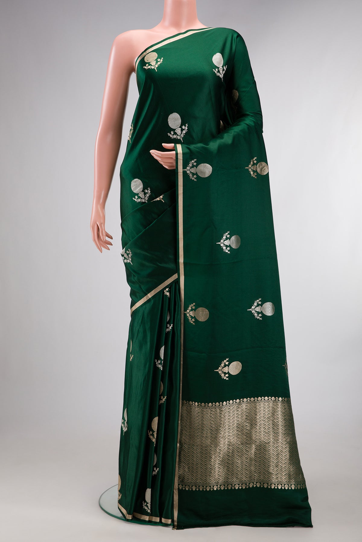 Pure Silk Bottle Green Banarasi Saree with Zari Butta on the body and Zari Border.  displayed on a mannequin