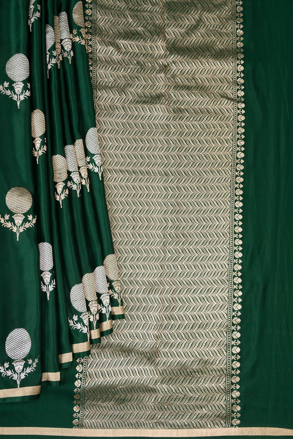 Pleats and pallu of Pure Silk Bottle Green Banarasi Saree with Zari Butta on the body and Zari Border. 