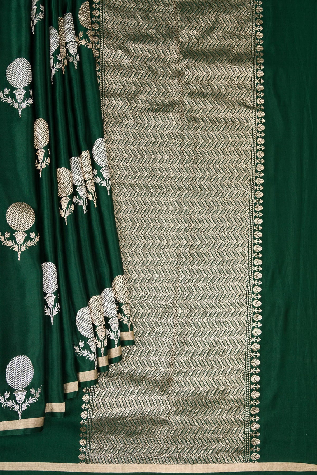 Pleats and pallu of Pure Silk Bottle Green Banarasi Saree with Zari Butta on the body and Zari Border. 