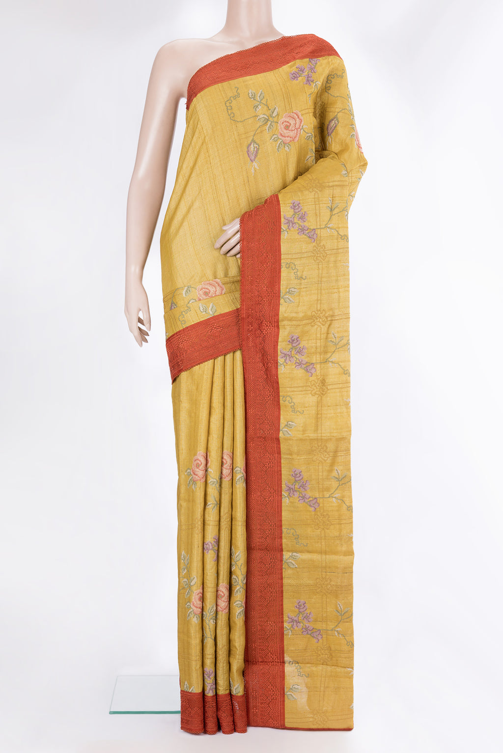 Mustard Tussar Saree with Embroidery on the body and Embroidery Border.  displayed on a mannequin