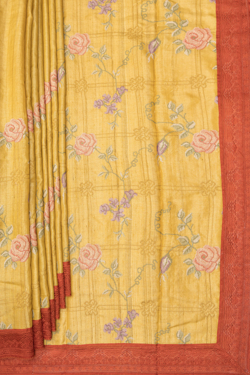 Pleats and pallu of Mustard Tussar Saree with Embroidery on the body and Embroidery Border. 
