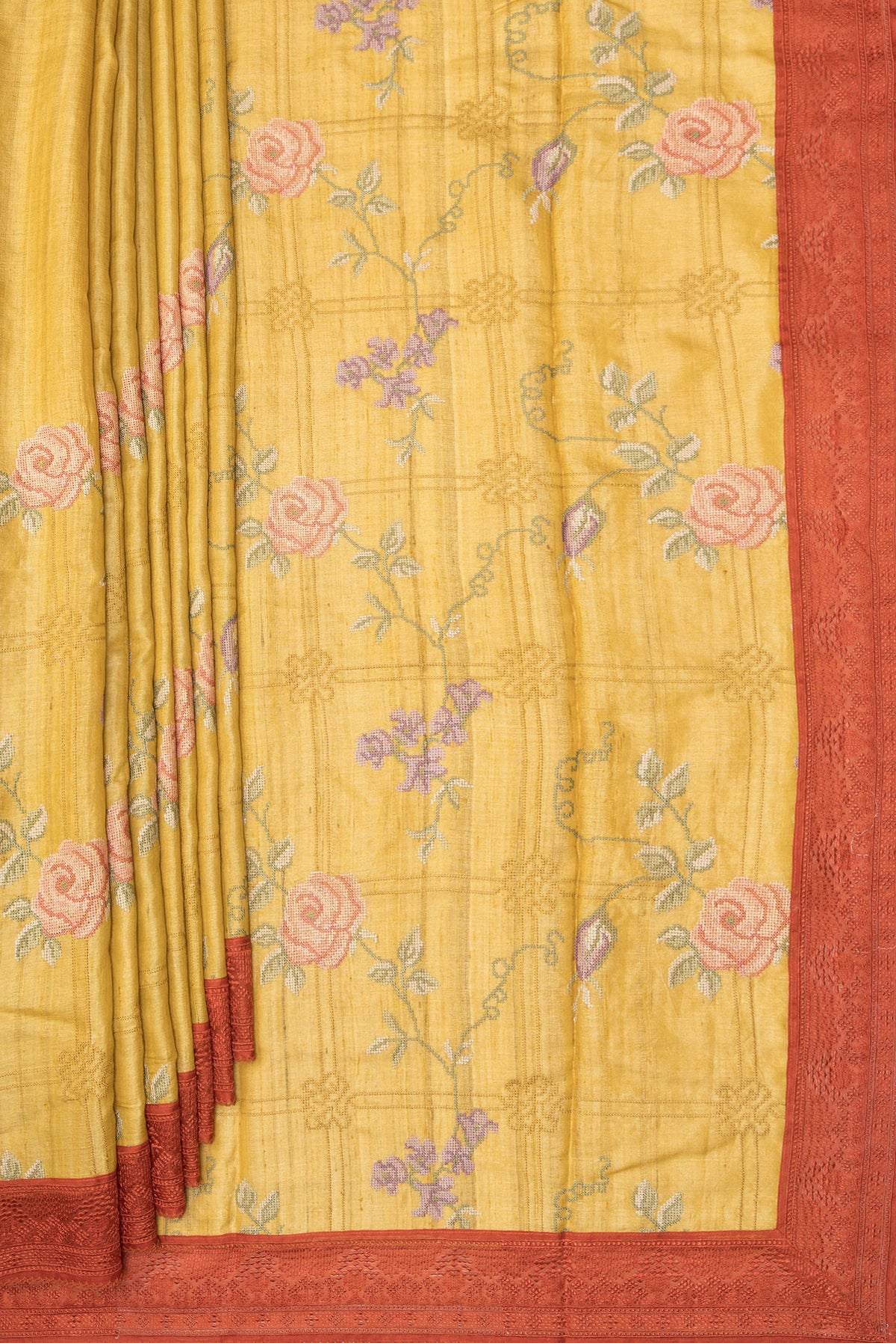 Pleats and pallu of Mustard Tussar Saree with Embroidery on the body and Embroidery Border. 