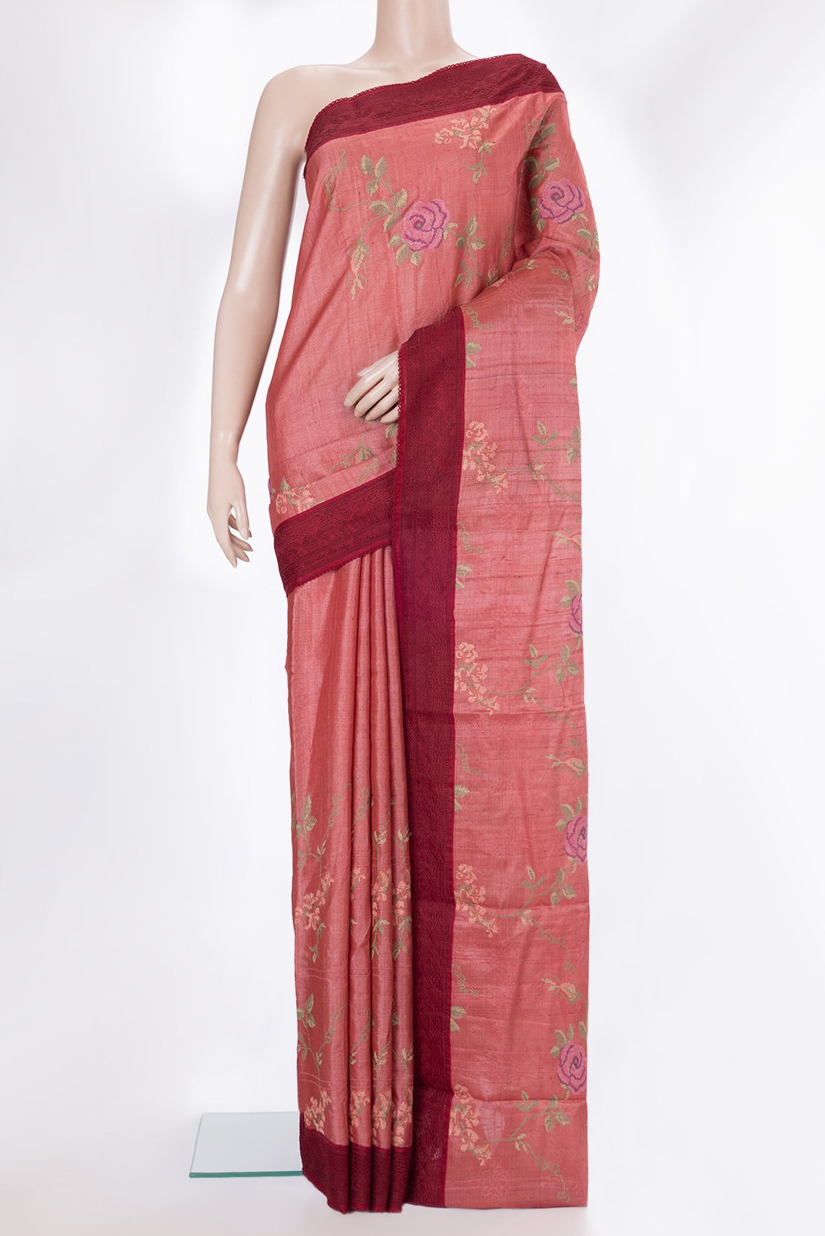 Coral Tussar Saree with Embroidery on the body and Embroidery Border.  displayed on a mannequin