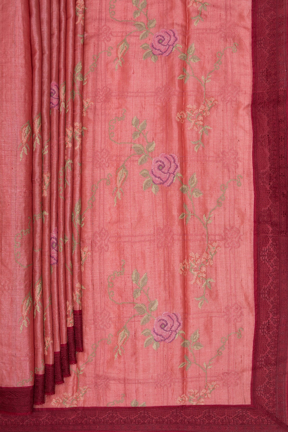 Pleats and pallu of Coral Tussar Saree with Embroidery on the body and Embroidery Border. 