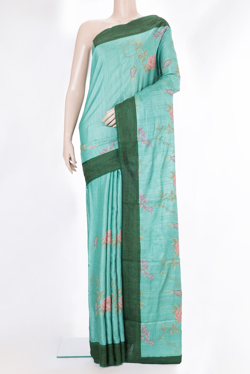 Sea Green Tussar Saree with Embroidery on the body and Embroidery Border.  displayed on a mannequin