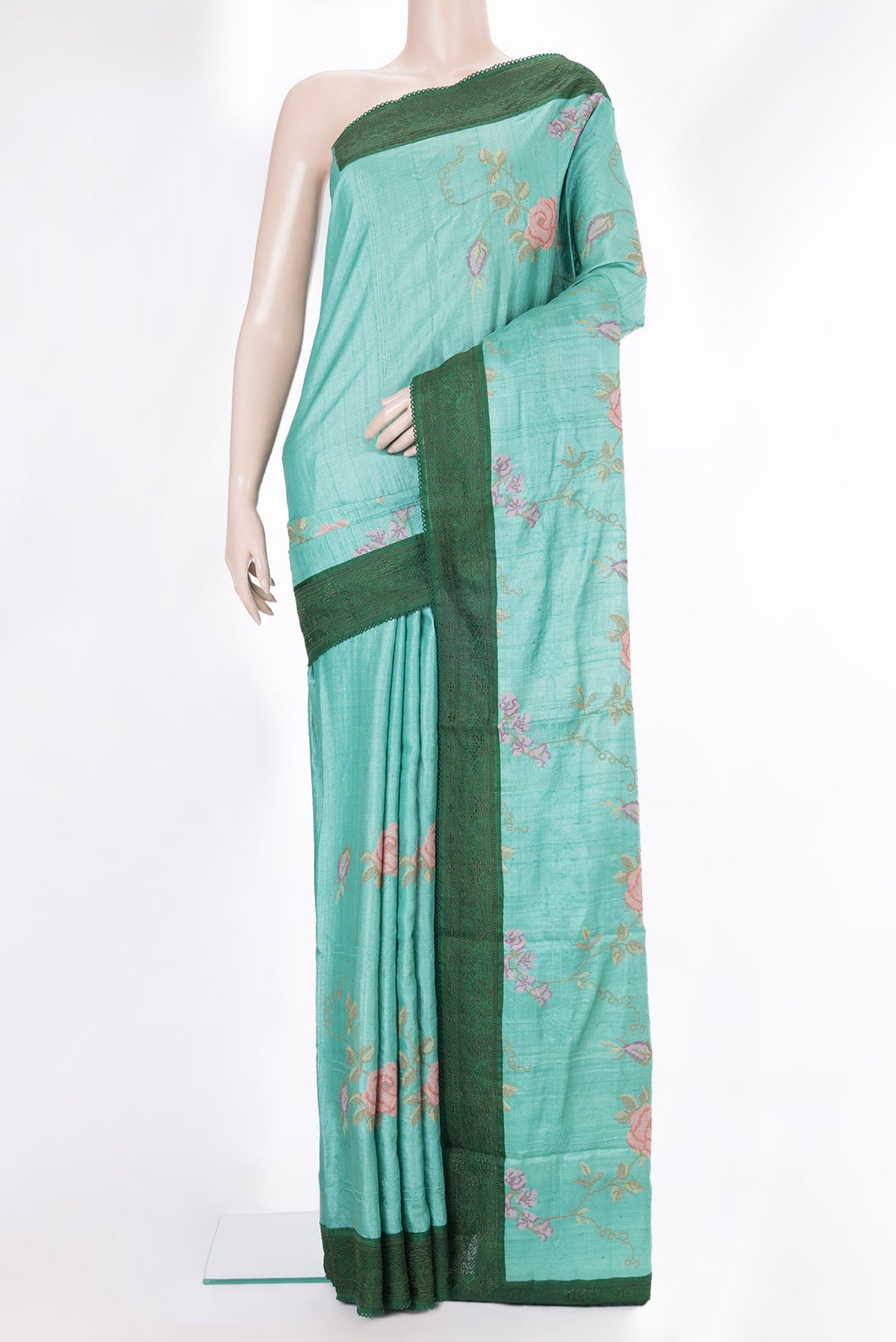 Sea Green Tussar Saree with Embroidery on the body and Embroidery Border.  displayed on a mannequin