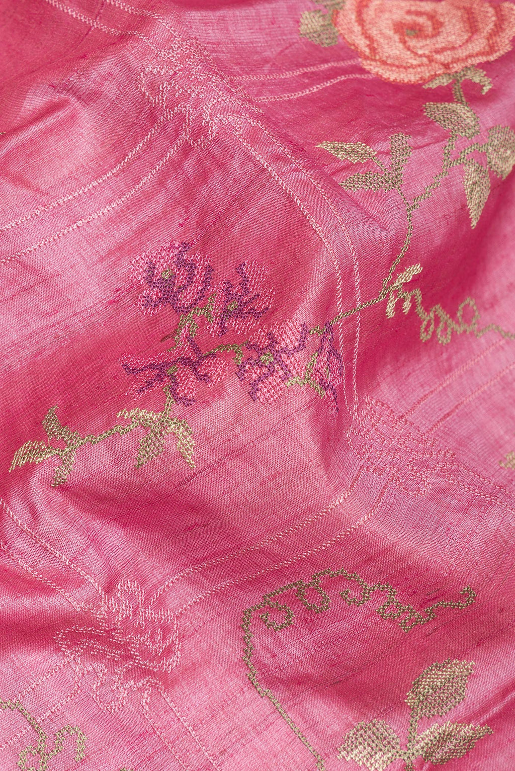 Close up of Pink Tussar Saree with Embroidery on the body and Embroidery Border.  displaying folds