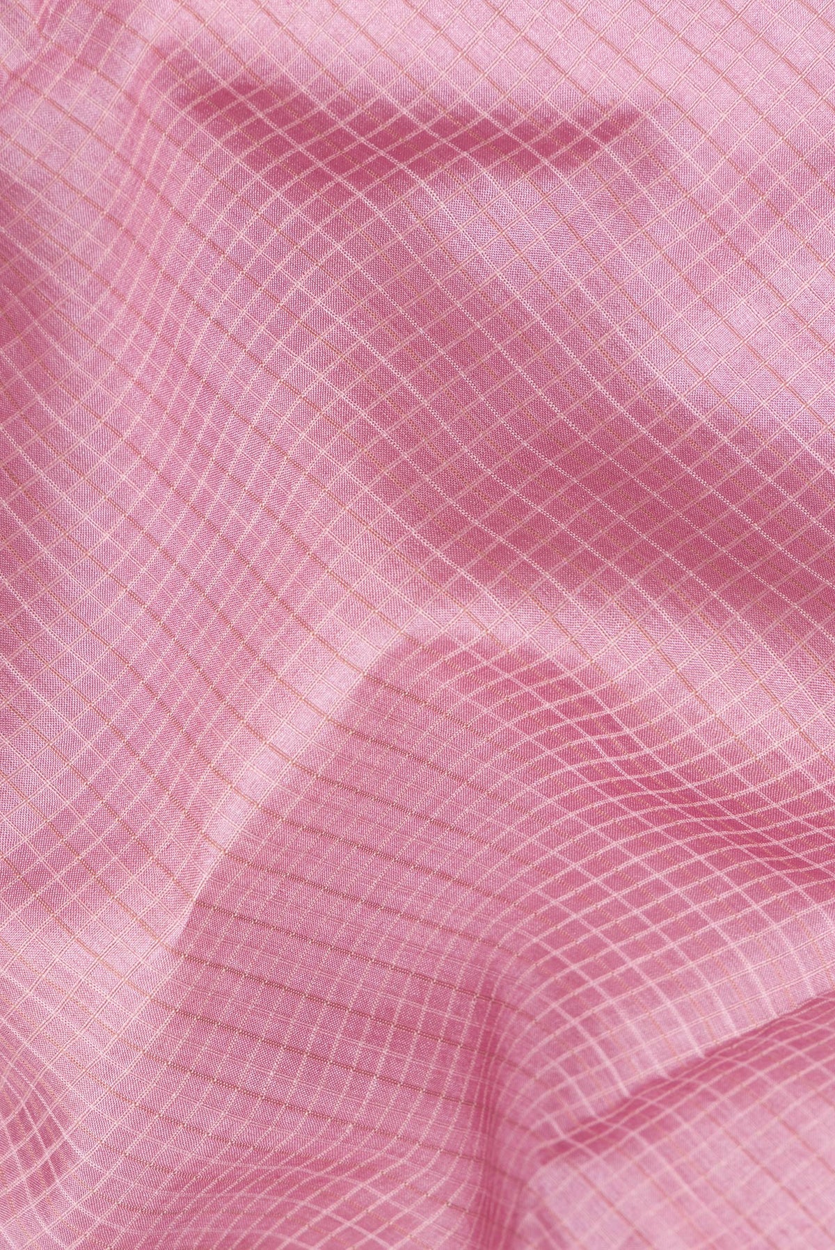 Close up of Pink Dual Tone Tussar Saree with Checked design on the body and Embroidery Border.  displaying folds
