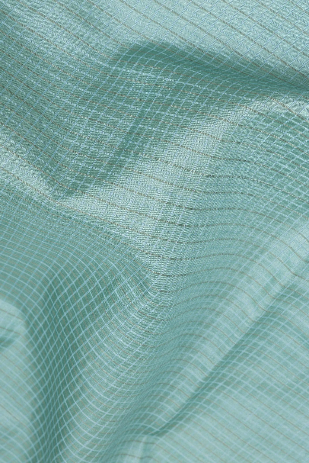 Close up of Sky Blue Tussar Saree with Checked design on the body and Embroidery Border.  displaying folds