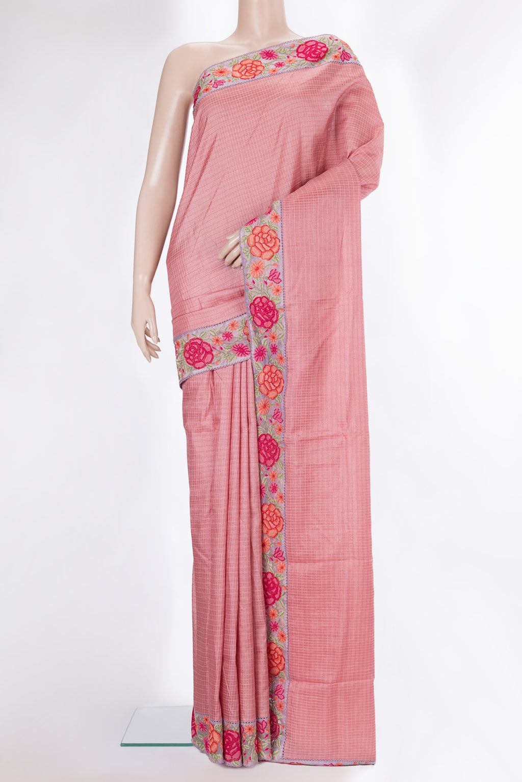 Peach Tussar Saree with Checked design on the body and Embroidery Border.  displayed on a mannequin
