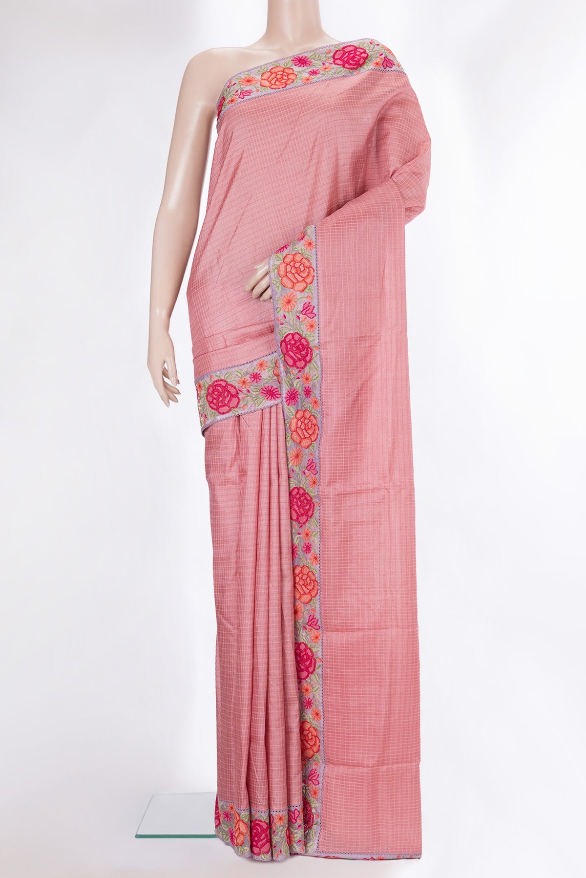 Peach Tussar Saree with Checked design on the body and Embroidery Border.  displayed on a mannequin