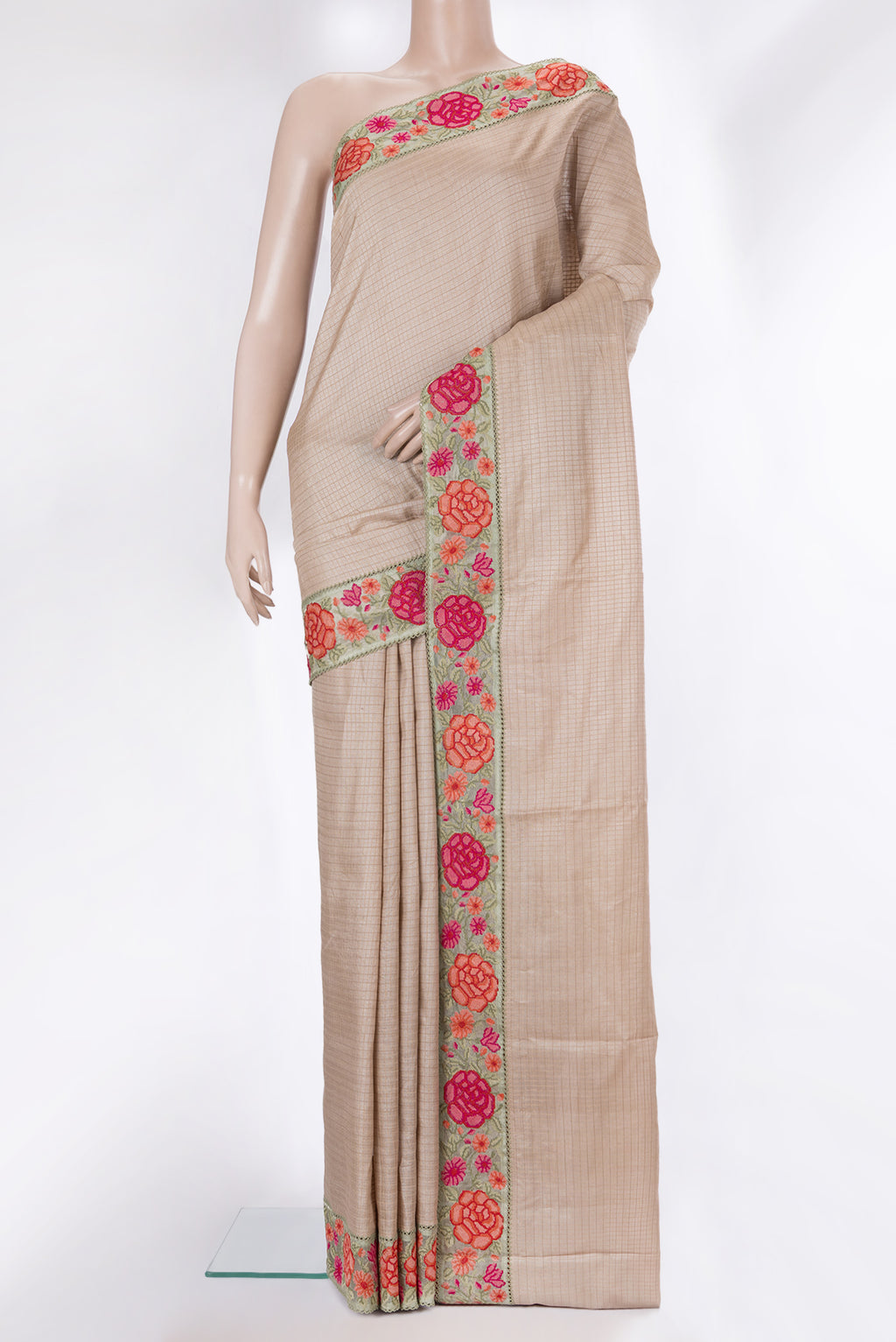 Beige Tussar Saree with Checked design on the body and Embroidery Border.  displayed on a mannequin