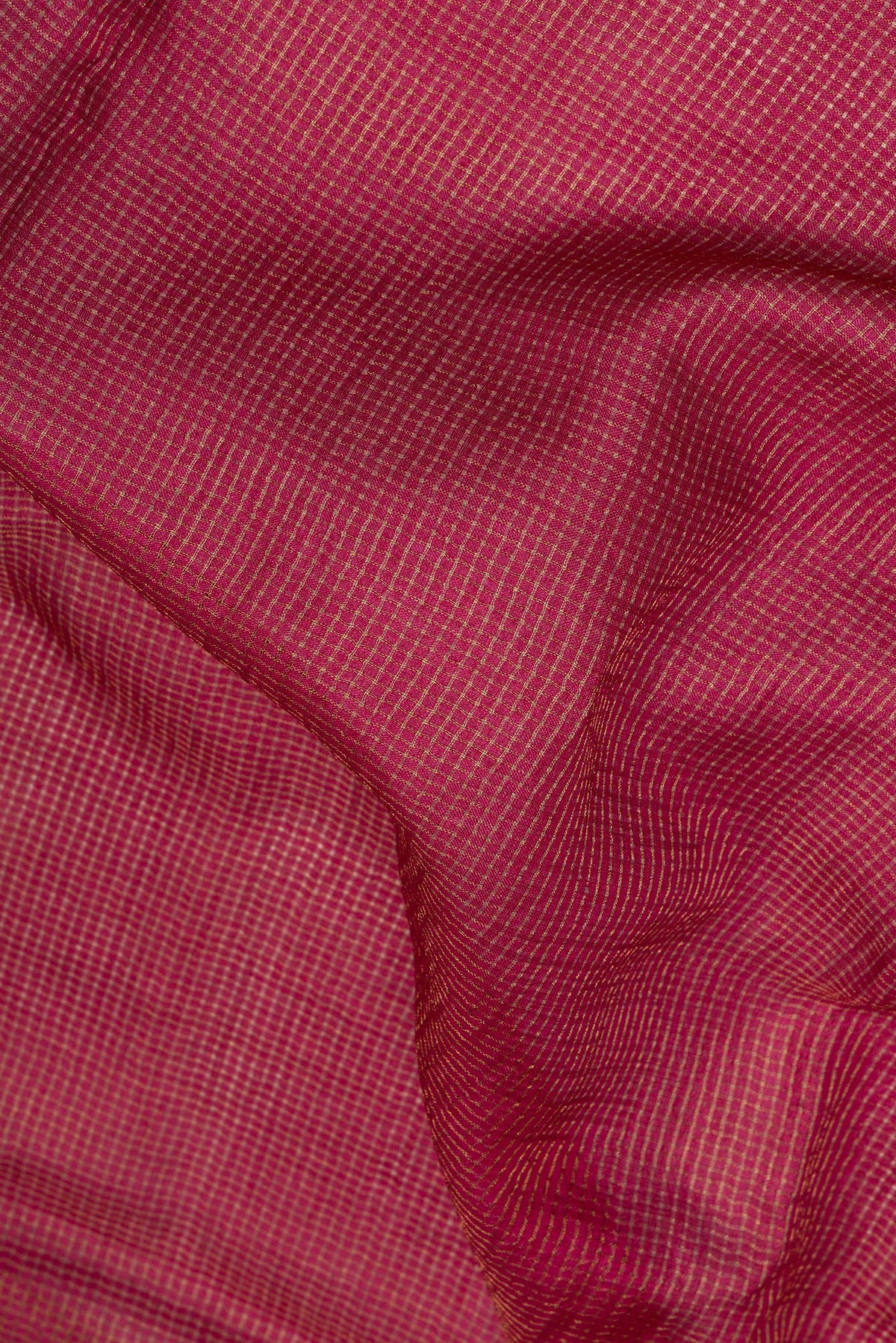 Close up of Maroon Dual Tone Tussar Saree with Checked design on the body and Embroidery Border.  displaying folds