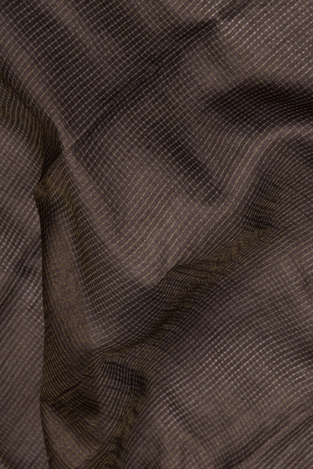 Close up of Brown Dual Tone Tussar Saree with Checked design on the body and Embroidery Border.  displaying folds
