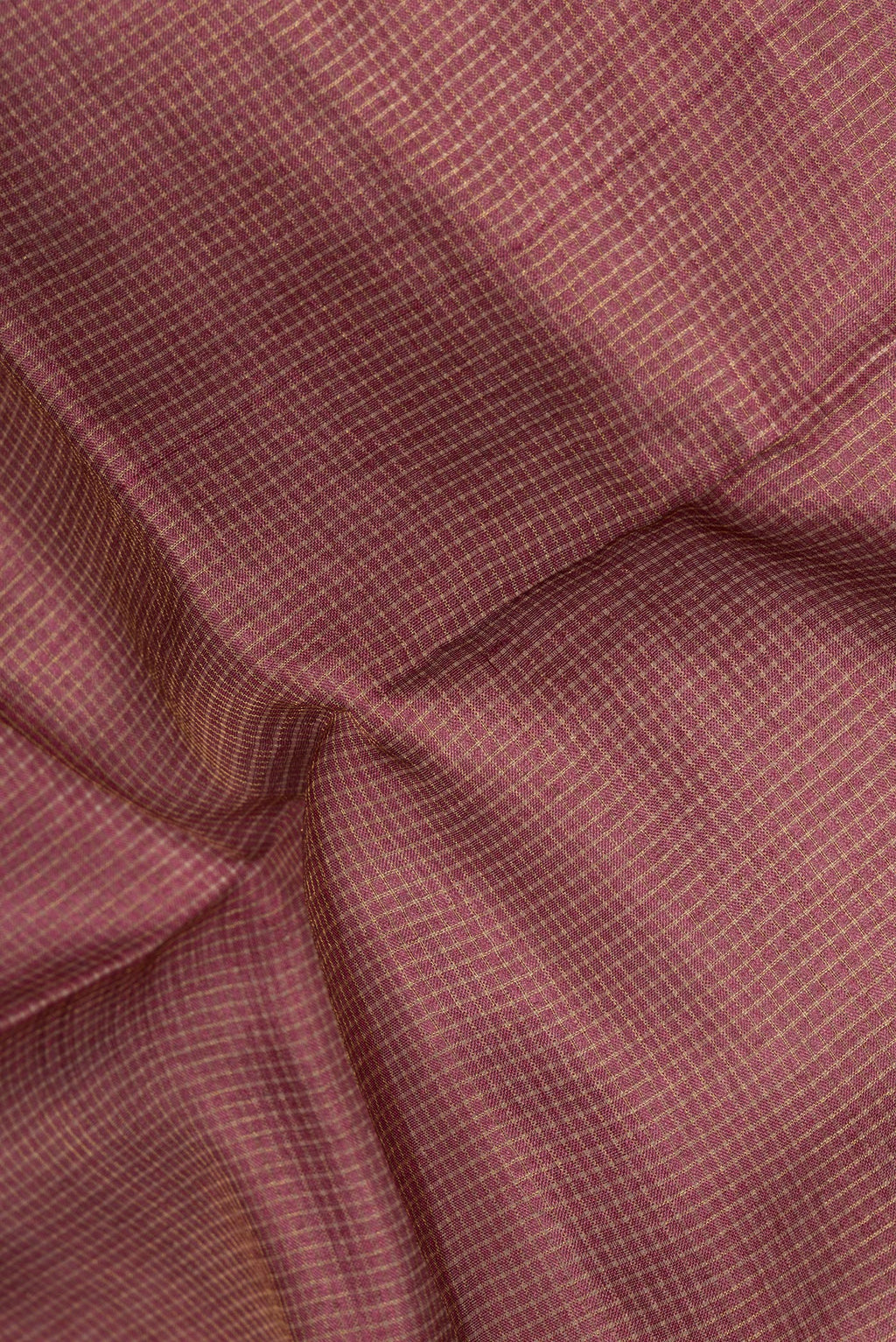 Close up of Brown Tussar Saree with Checked design on the body and Embroidery Border.  displaying folds