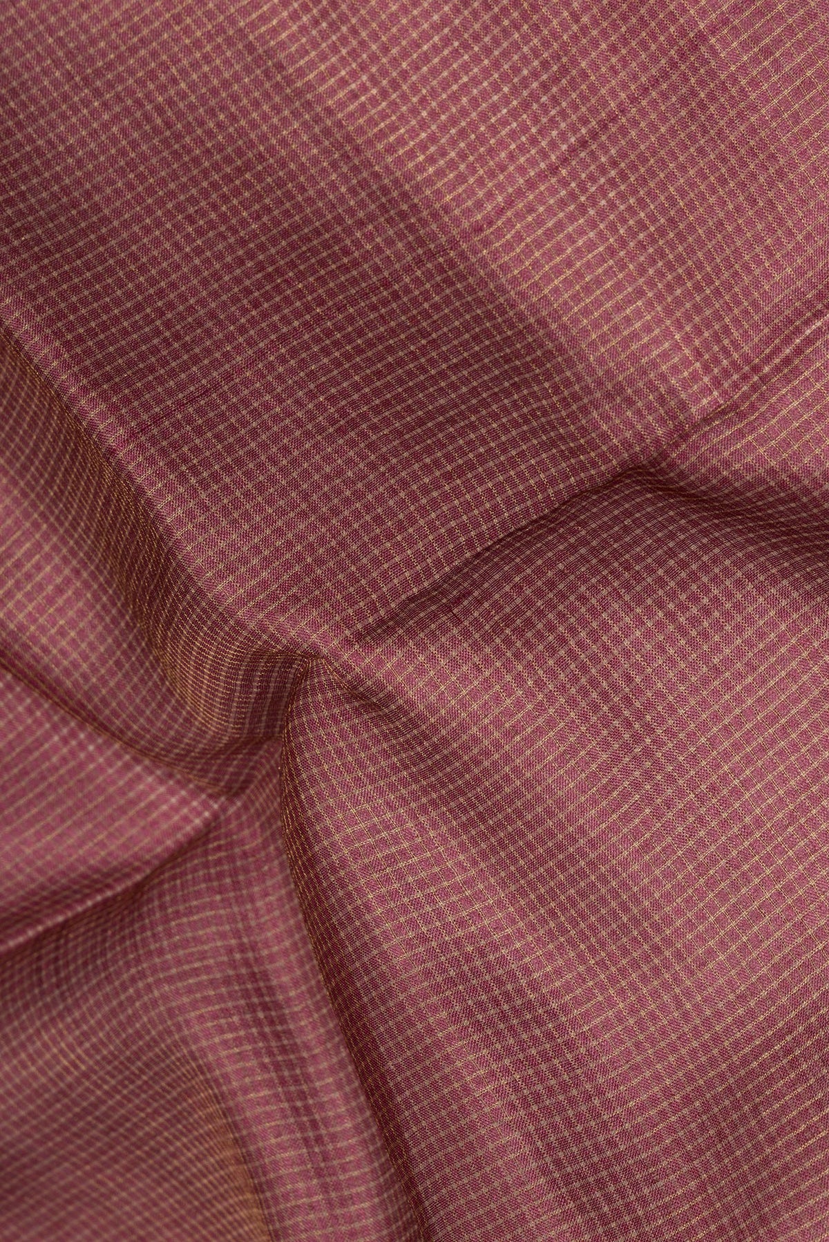 Close up of Brown Tussar Saree with Checked design on the body and Embroidery Border.  displaying folds