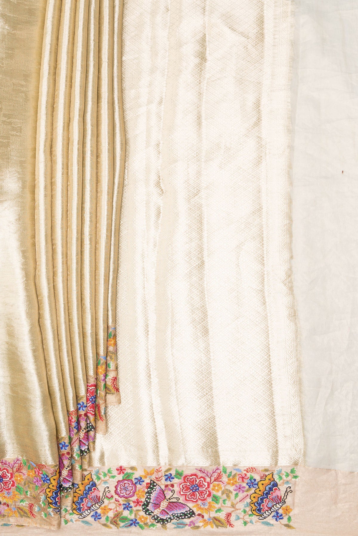 Pleats and pallu of Gold Dual Tone Banarasi Tissue Saree with Zari Brocade on the body and Embroidery Border. 