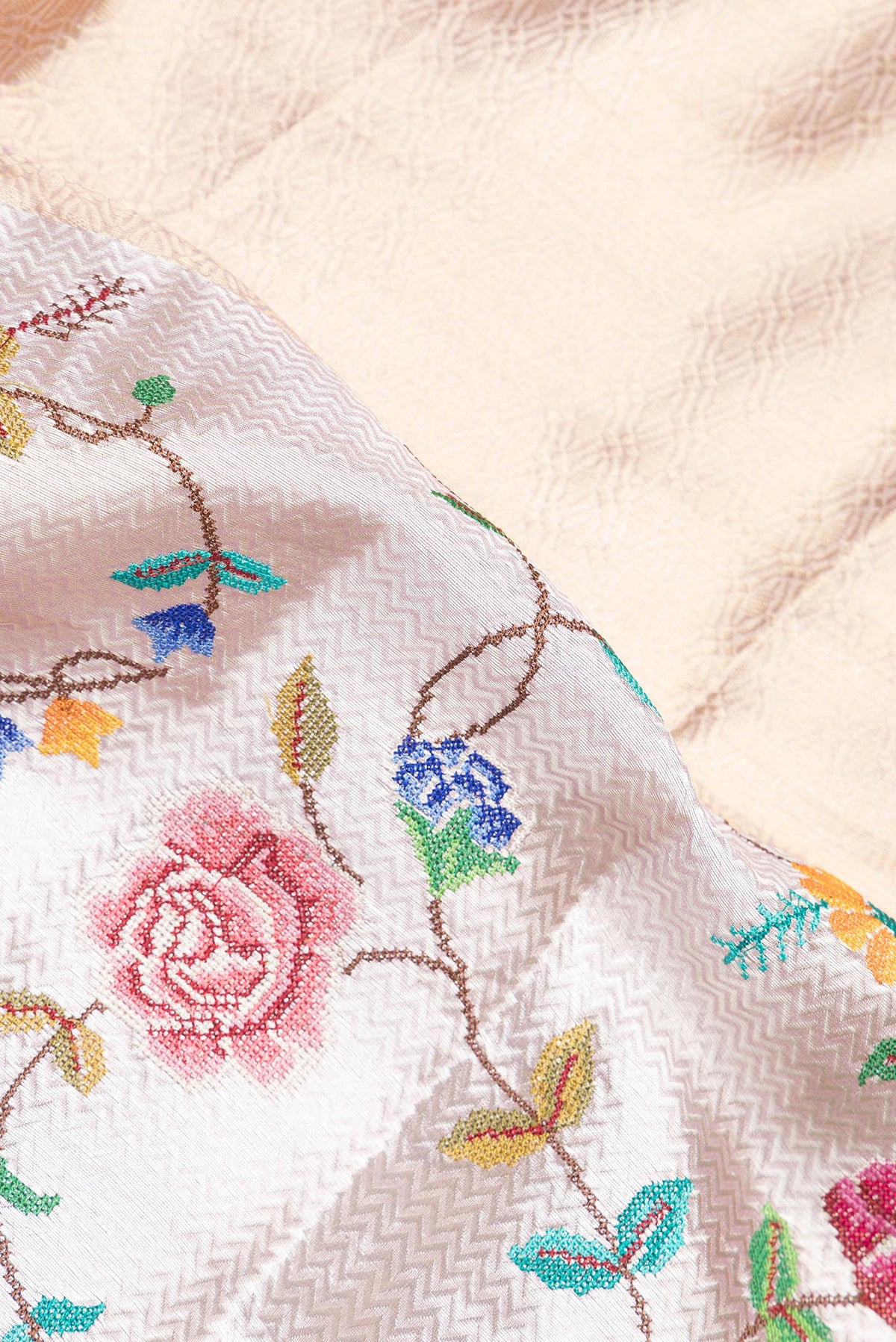 Close up of Gold and Lavender Color Banarasi Tissue Saree with Zari Brocade on the body and Embroidery Border.  displaying folds