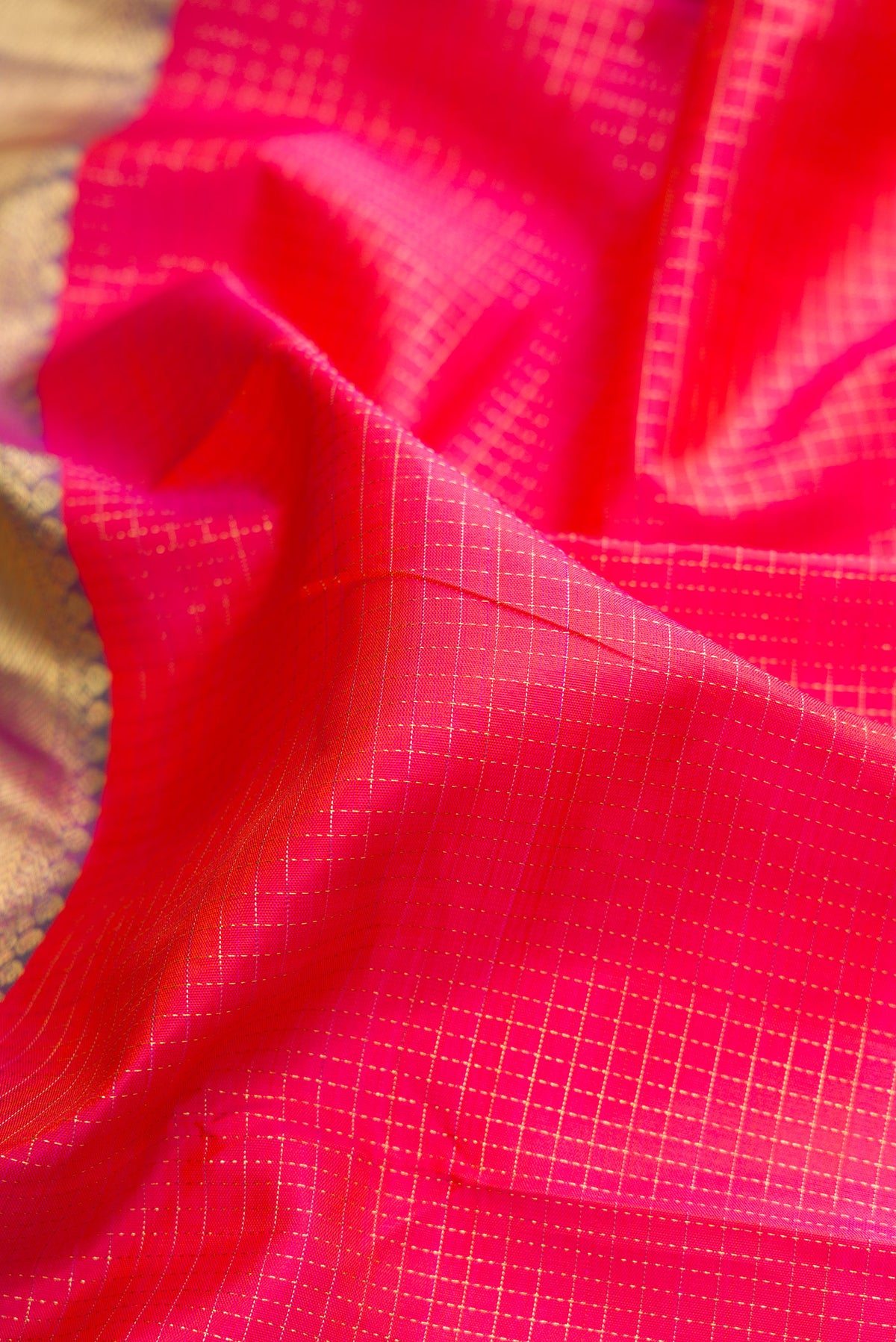 Close up of Pure Silk Pink Dual Tone Kanchipuram Saree with Checked design on the body and Zari Border.  displaying folds