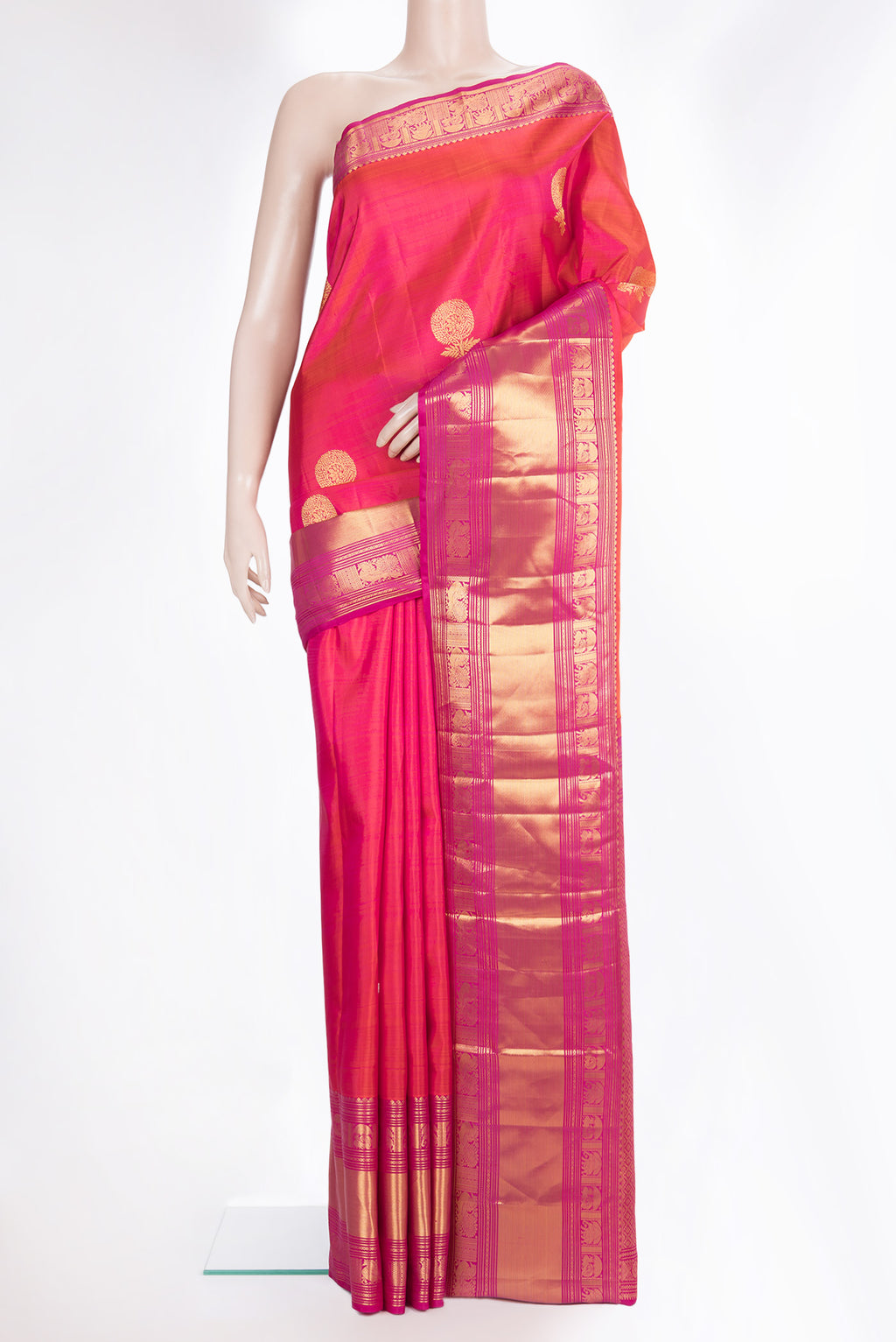 Pure Silk Coral Dual Tone Kanchipuram Saree with Zari Butta on the body and Fancy Border.  displayed on a mannequin