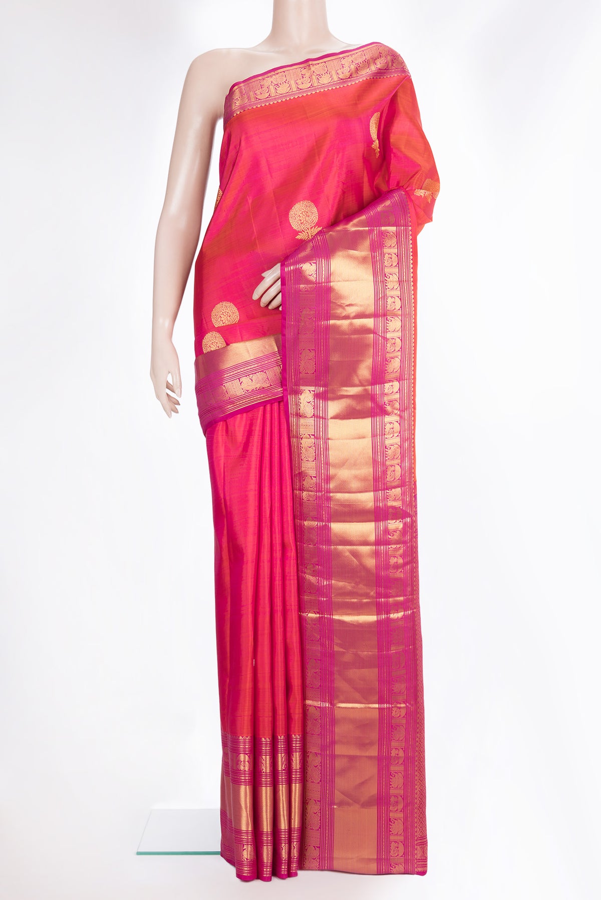 Pure Silk Coral Dual Tone Kanchipuram Saree with Zari Butta on the body and Fancy Border.  displayed on a mannequin