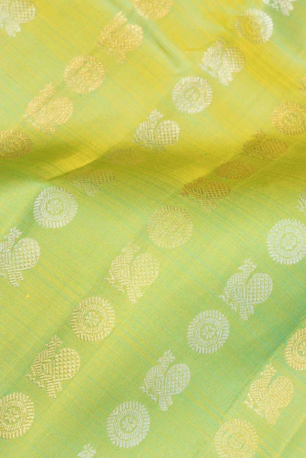 Close up of Pure Silk Green Dual Tone Kanjivaram Saree with Zari Butta on the body and Zari Border.  displaying folds