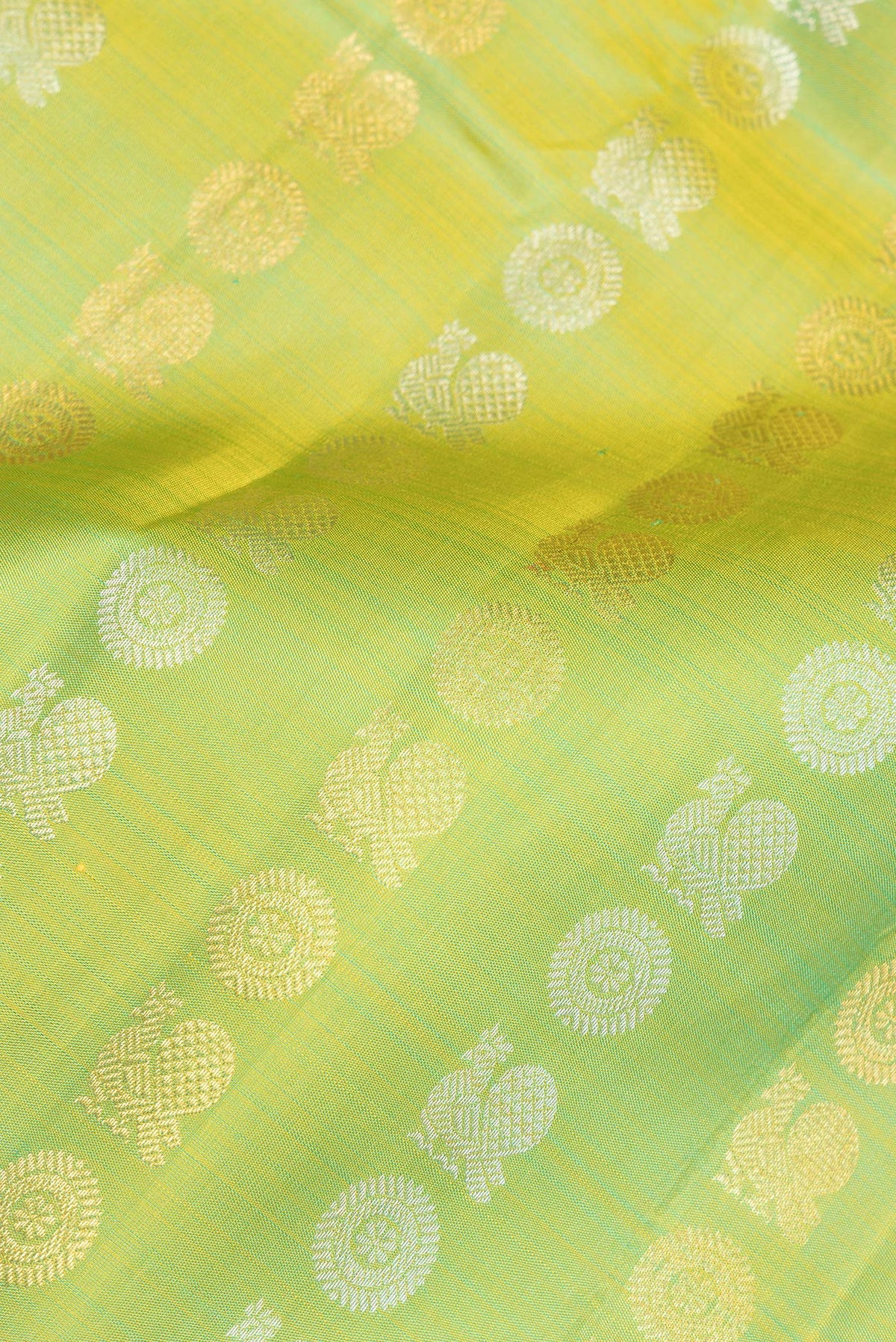 Close up of Pure Silk Green Dual Tone Kanjivaram Saree with Zari Butta on the body and Zari Border.  displaying folds