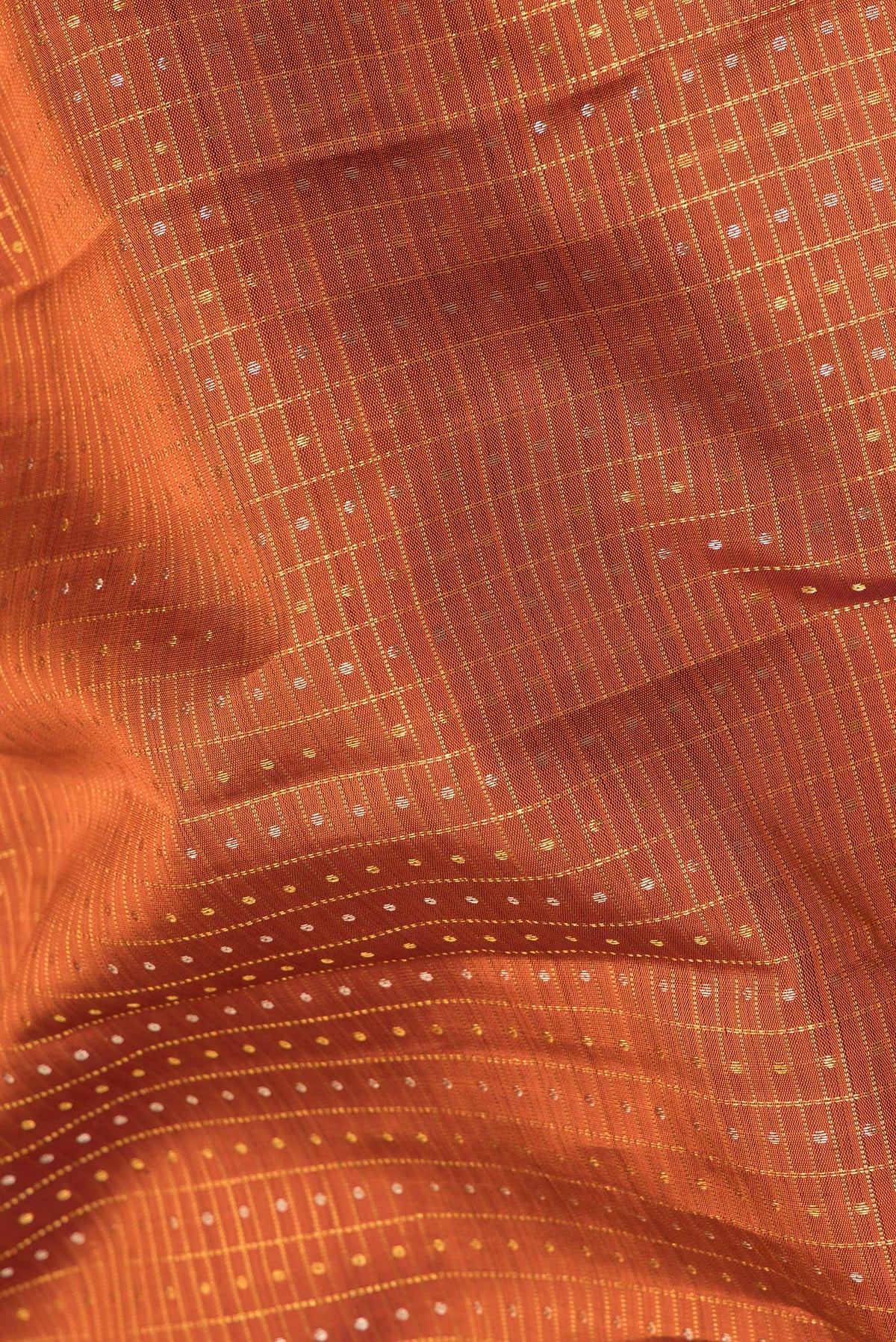 Close up of Pure Silk Orange Kanjivaram Saree with Checked design on the body and Zari Border.  displaying folds