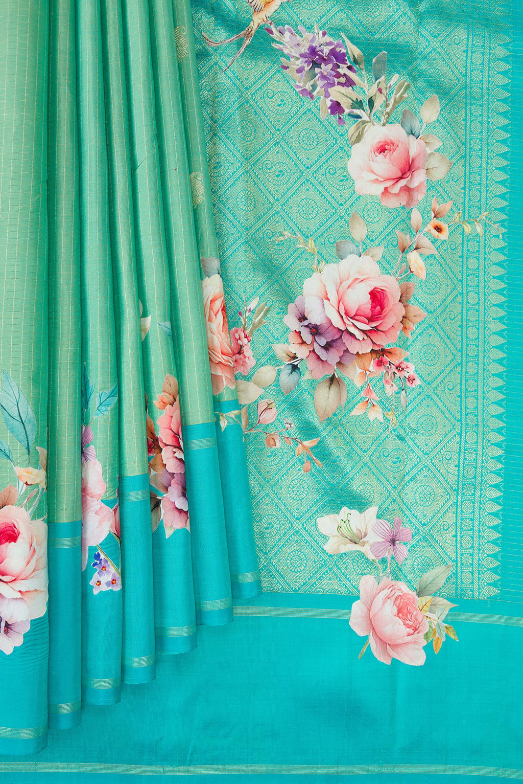 Pleats and pallu of Pure Silk Sea Green Kanchipuram Saree with Zari Butta on the body and Fancy Border. 