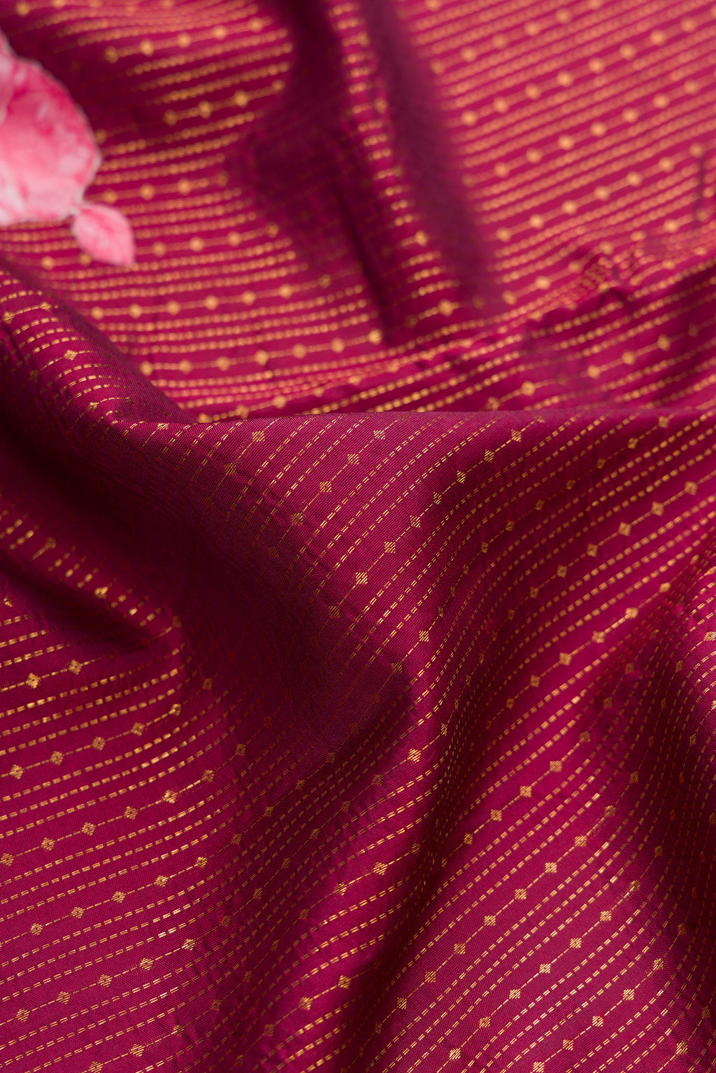 Close up of Pure Silk Maroon Kanchipuram Saree with Stripes on the body and Fancy Border.  displaying folds