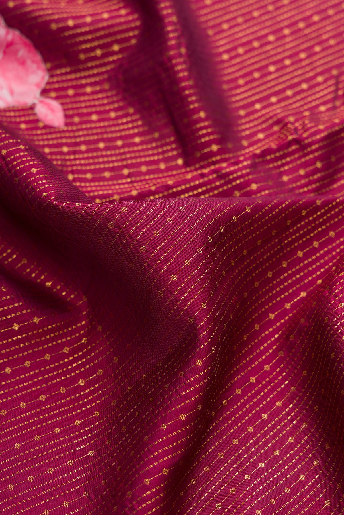 Close up of Pure Silk Maroon Kanchipuram Saree with Stripes on the body and Fancy Border.  displaying folds