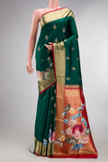 Pure Silk Green Kanjivaram Saree with Zari Butta on the body and Fancy Border.  displayed on a mannequin