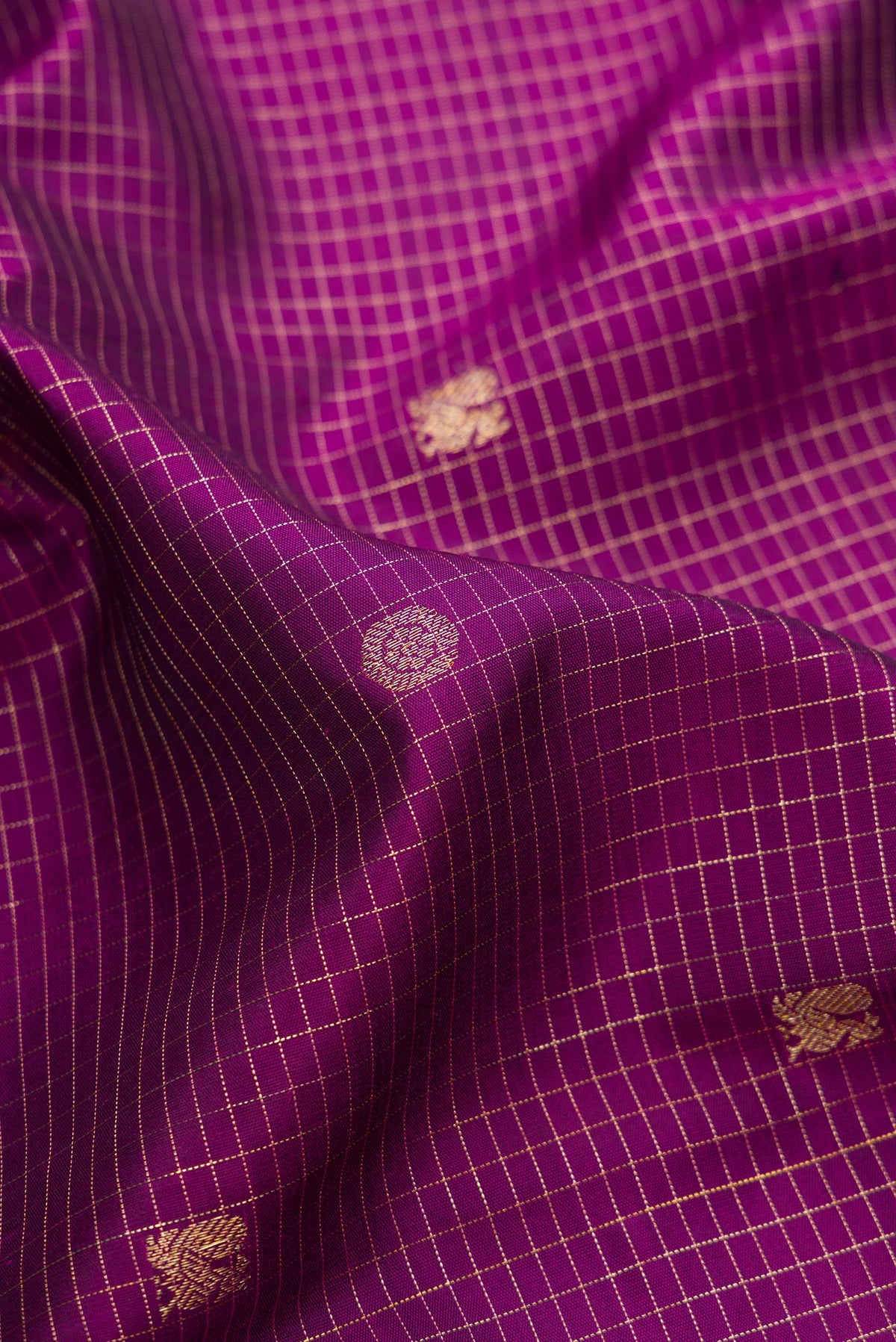 Close up of Pure Silk Purple Dual Tone Kanchipuram Saree with Checked design on the body and Fancy Border.  displaying folds