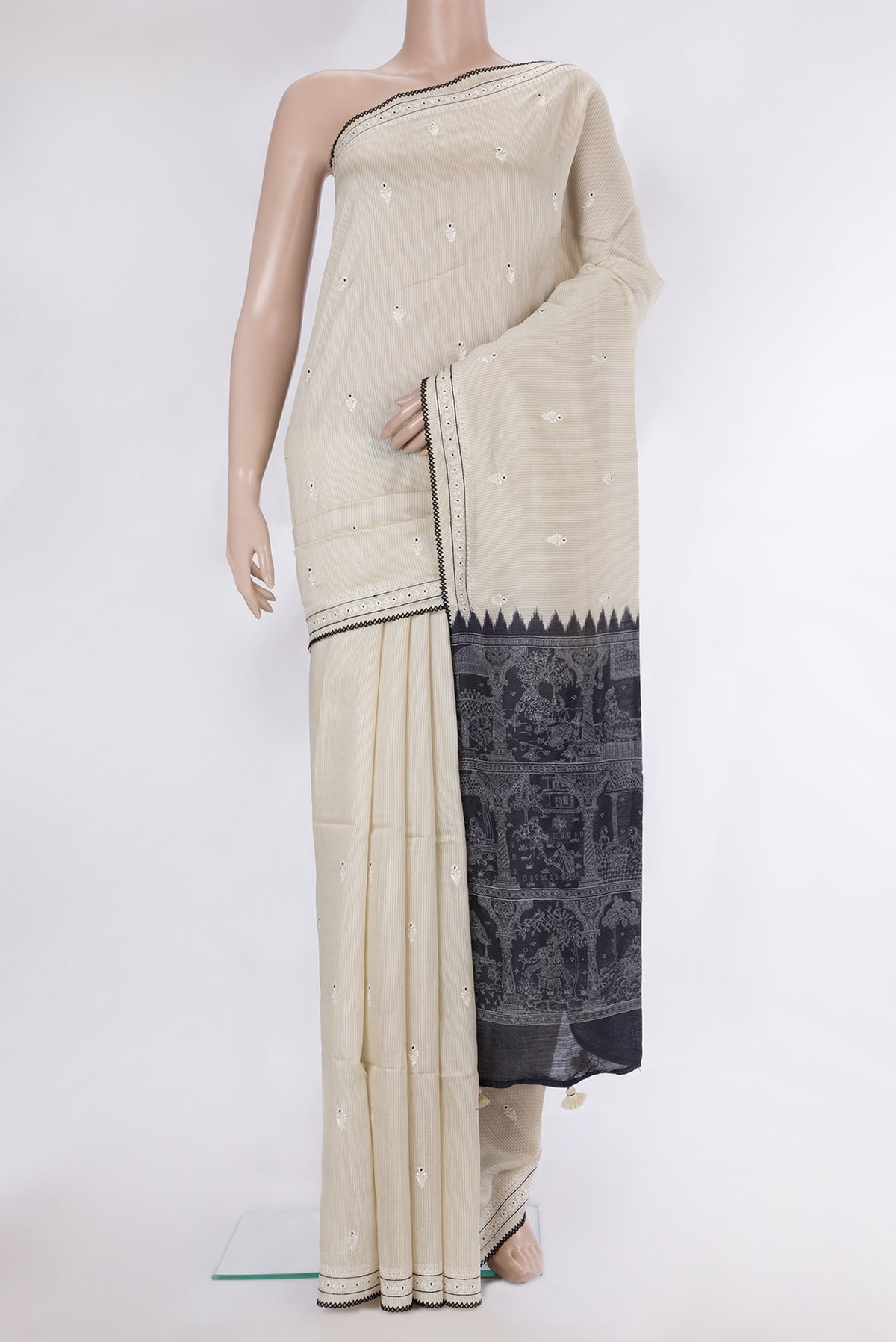 Cream Tussar Saree with Embroidery on the body and Embroidery Border.  displayed on a mannequin
