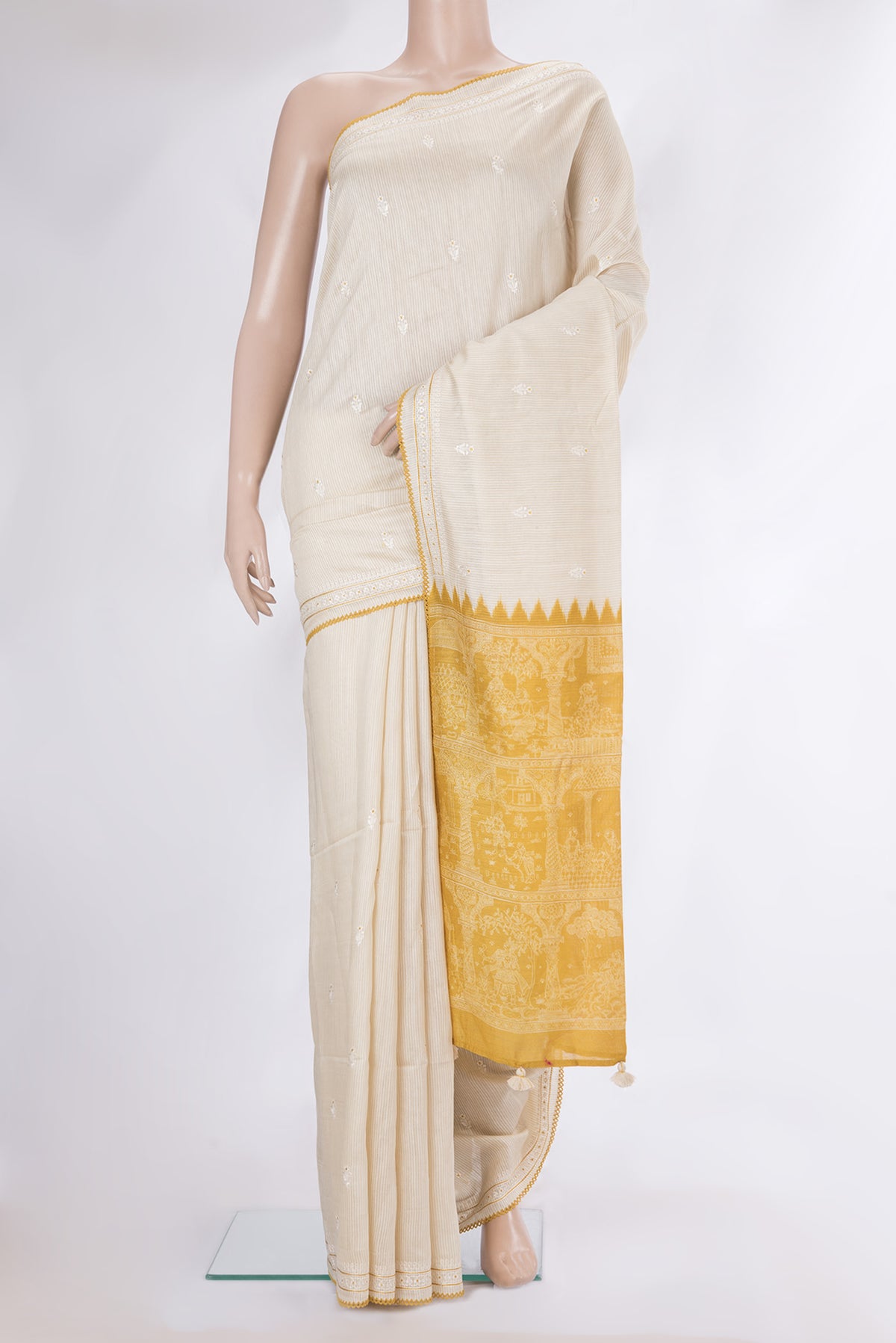 Cream Tussar Saree with Embroidery on the body and Embroidery Border.  displayed on a mannequin