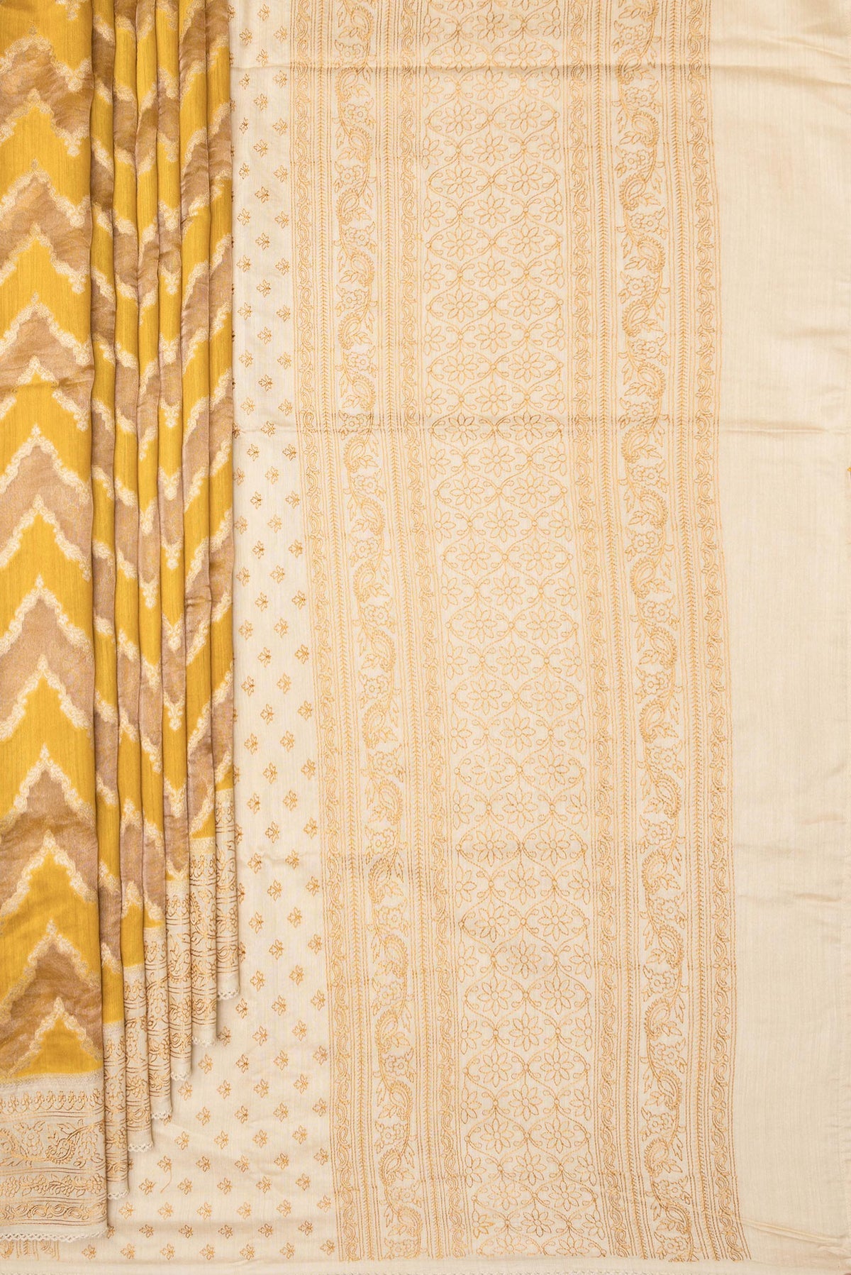 Pleats and pallu of Pure Silk Mustard Dual Tone Tussar Saree with Zari Brocade on the body and Embroidery Border. 