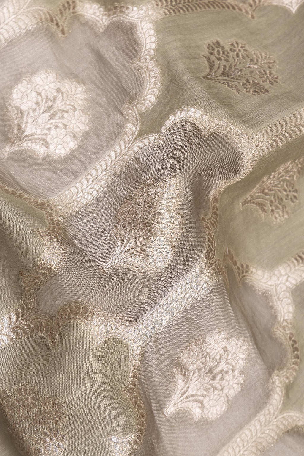 Close up of Pure Silk Grey Dual Tone Tussar Saree with Zari Brocade on the body and Embroidery Border.  displaying folds