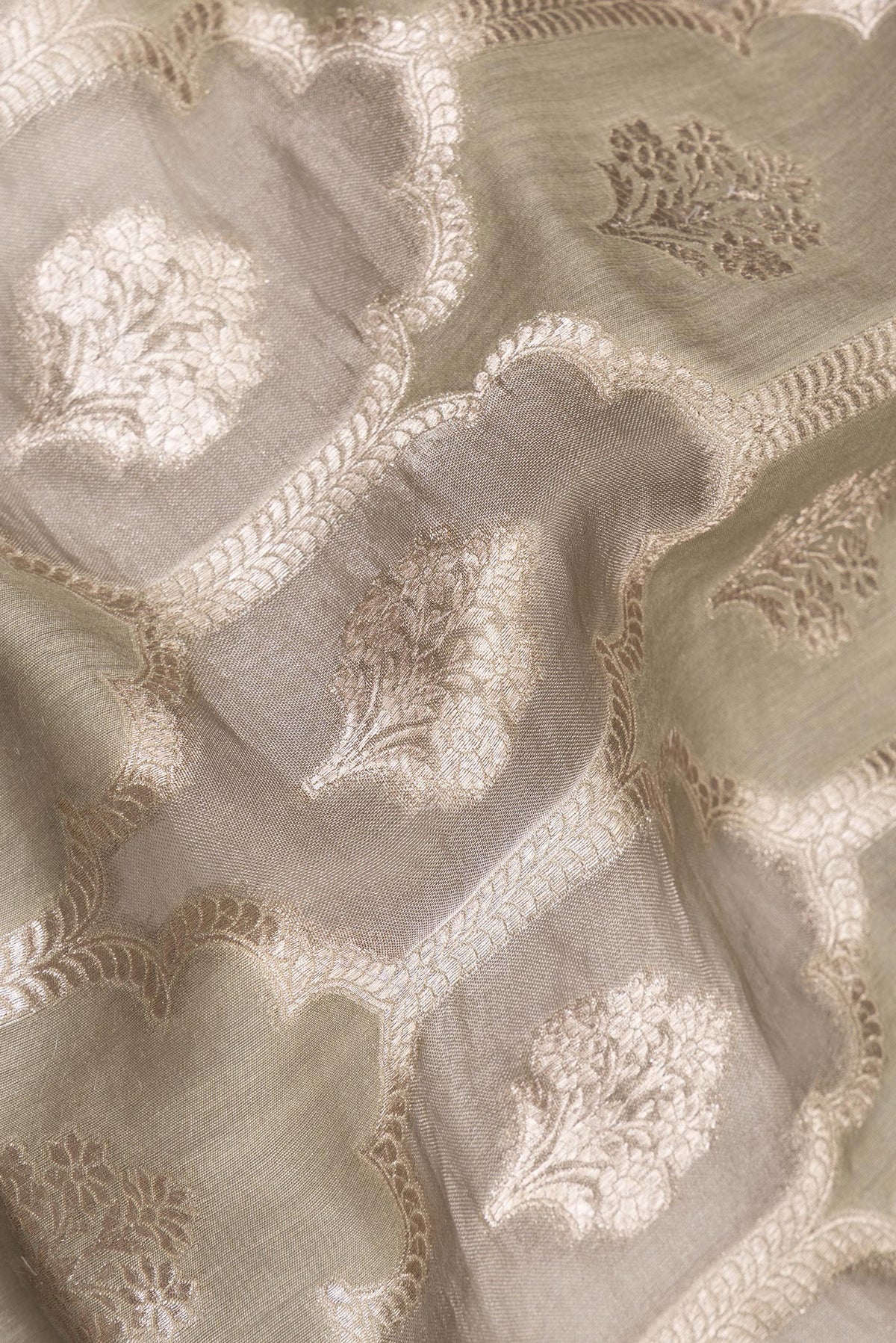 Close up of Pure Silk Grey Dual Tone Tussar Saree with Zari Brocade on the body and Embroidery Border.  displaying folds