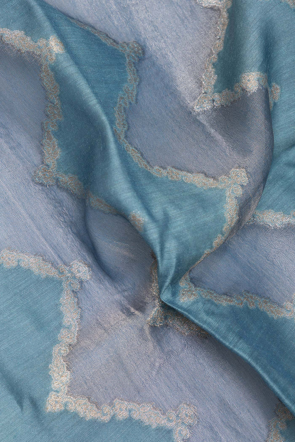 Close up of Light Blue Dual Tone Tussar Saree with Zari Brocade on the body and Embroidery Border.  displaying folds