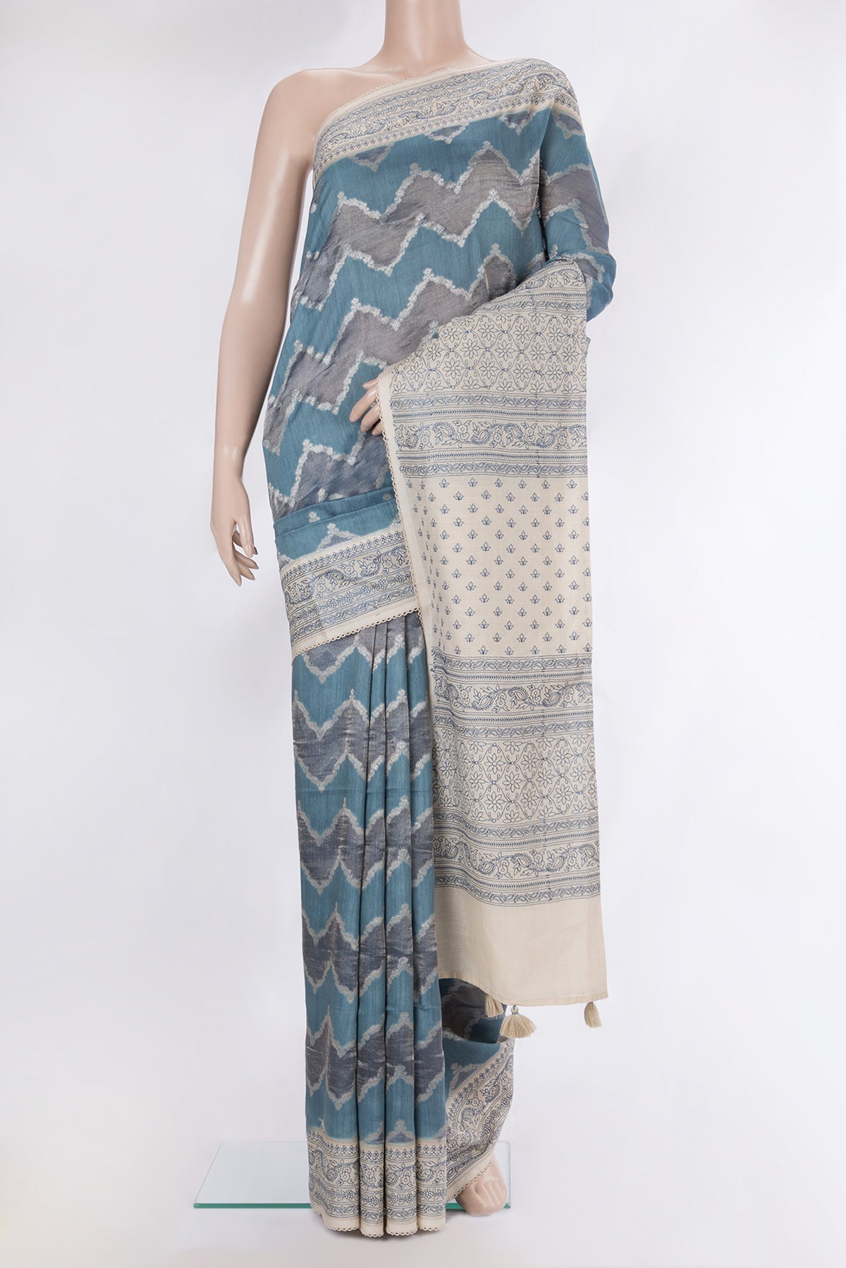 Light Blue Dual Tone Tussar Saree with Zari Brocade on the body and Embroidery Border.  displayed on a mannequin