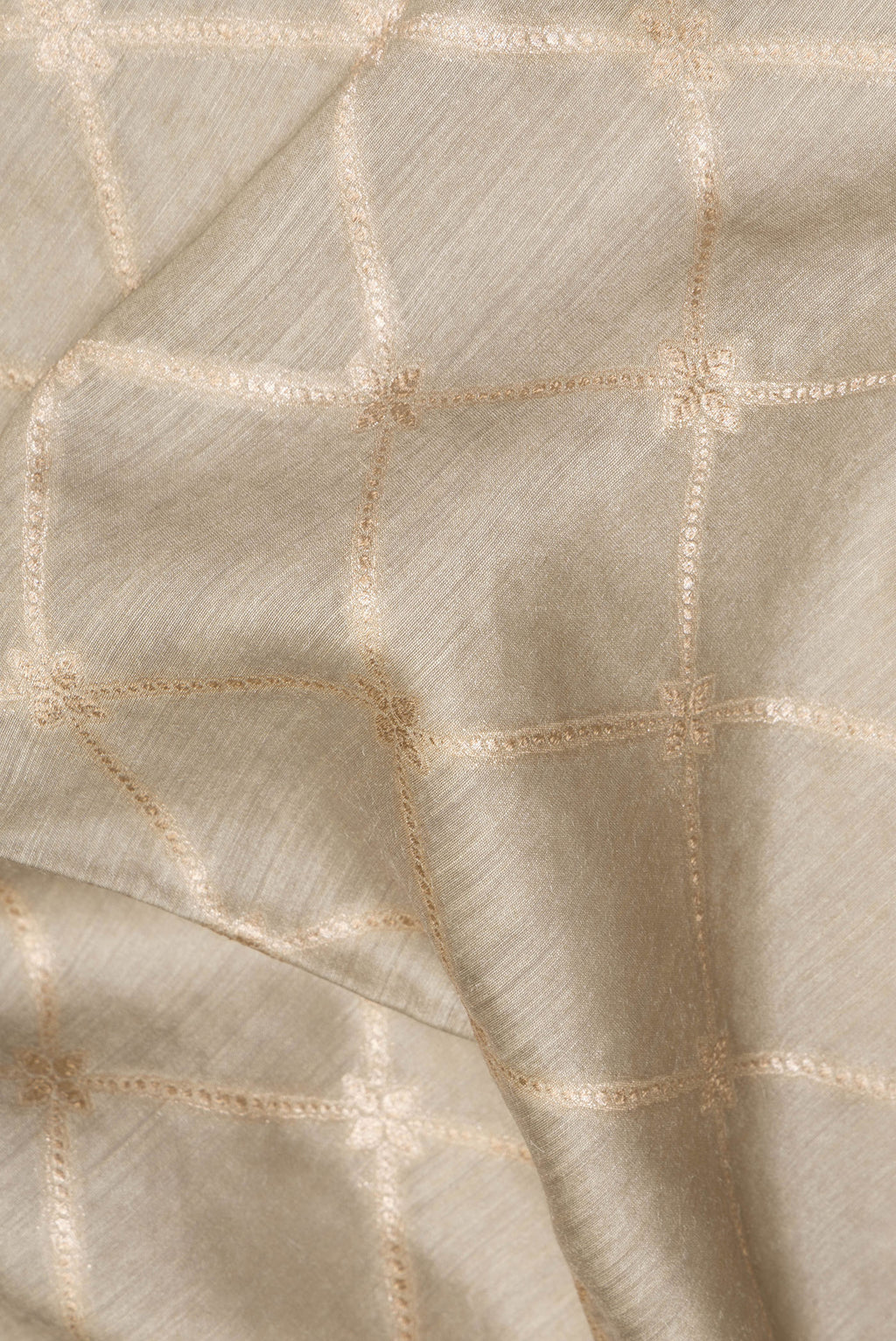 Close up of Pure Silk Grey Dual Tone Tussar Saree with Zari Brocade on the body and Embroidery Border.  displaying folds