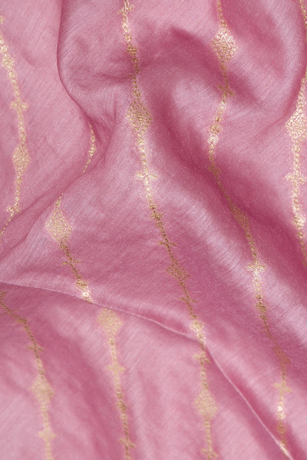 Close up of Pink Dual Tone Tussar Saree with Thread Butta on the body and Embroidery Border.  displaying folds