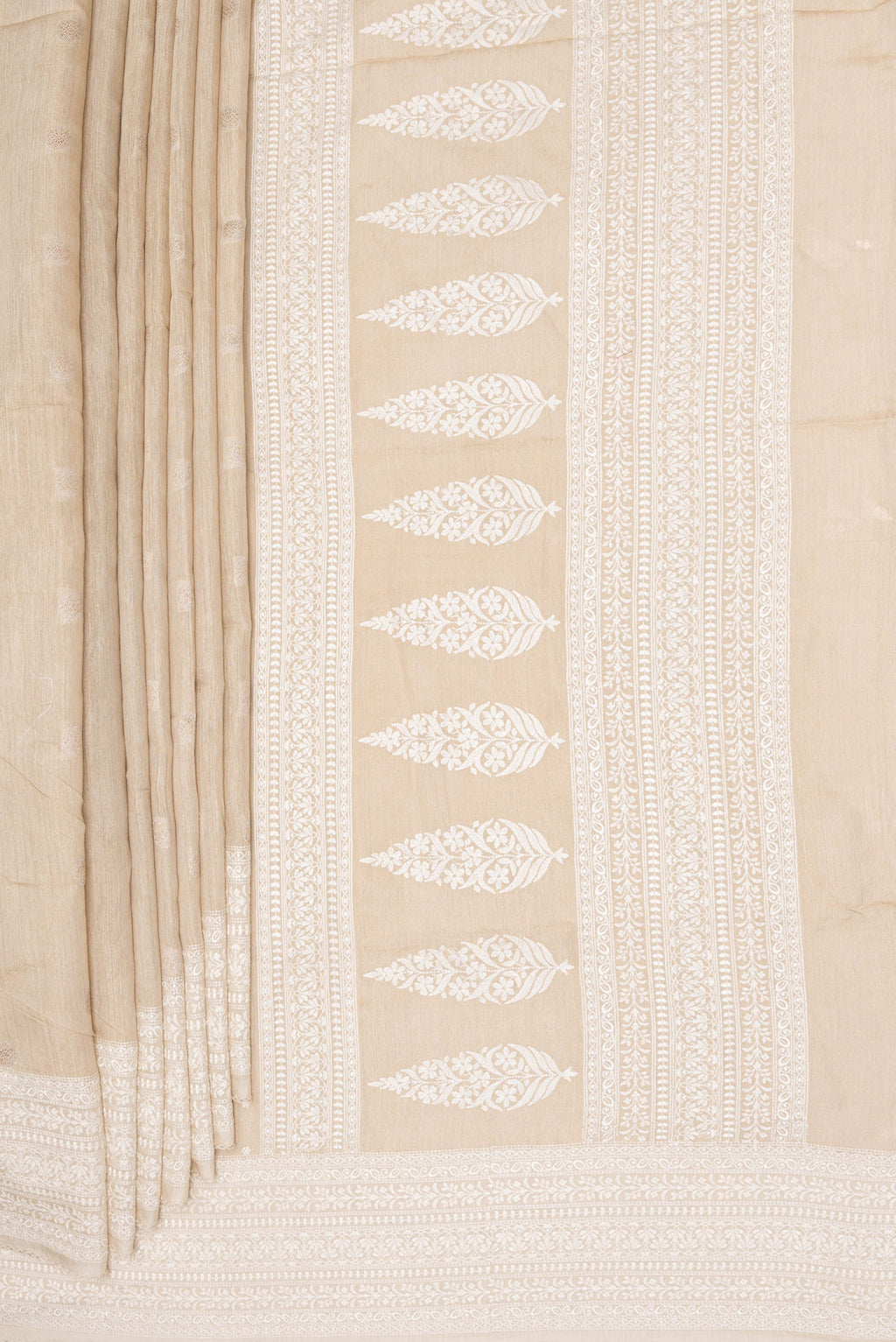 Pleats and pallu of Pure Silk Beige Tussar Saree with Thread Butta on the body and Embroidery Border. 