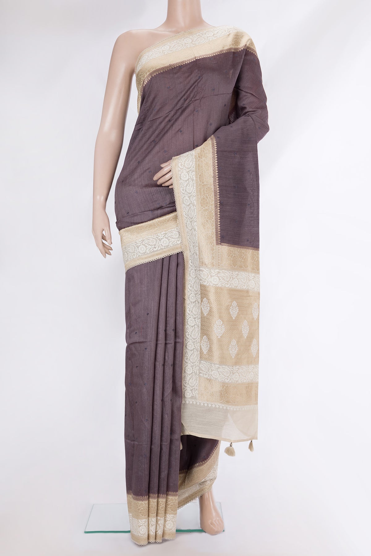 Brown Tussar Saree with Embroidery on the body and Embroidery Border.  displayed on a mannequin