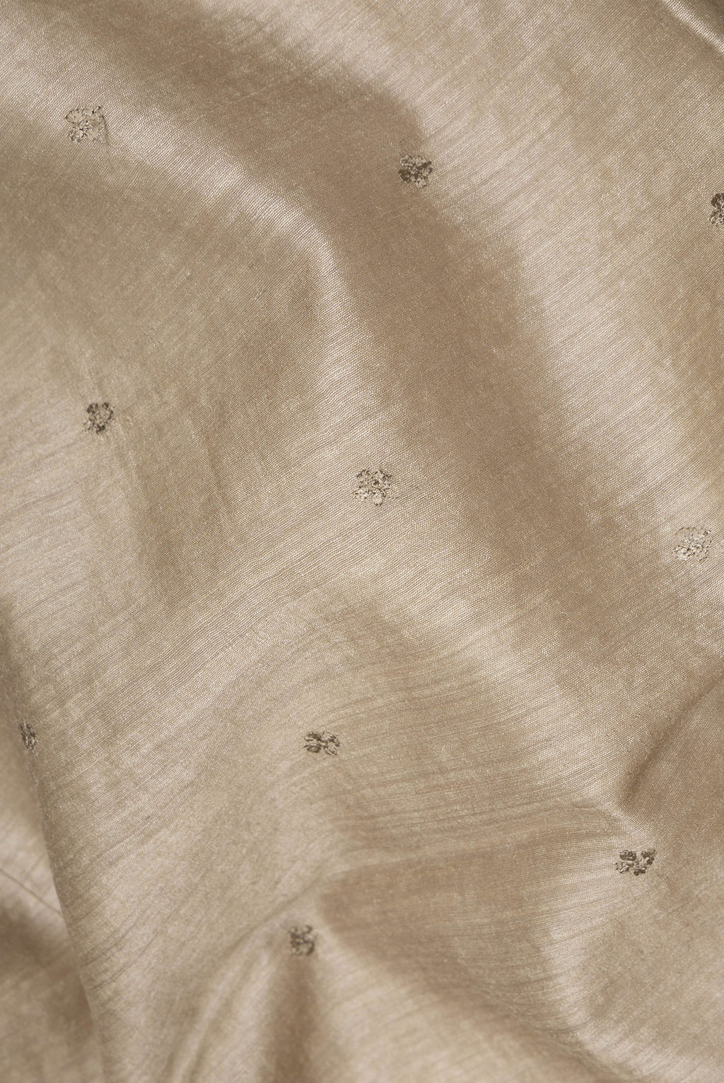 Close up of Pure Silk Dark Beige Tussar Saree with Embroidery on the body and Embroidery Border.  displaying folds