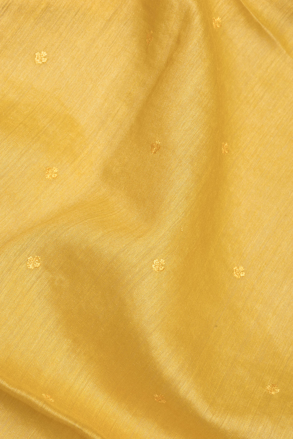 Close up of Pure Silk Mustard Dual Tone Tussar Saree with Embroidery on the body and Embroidery Border.  displaying folds