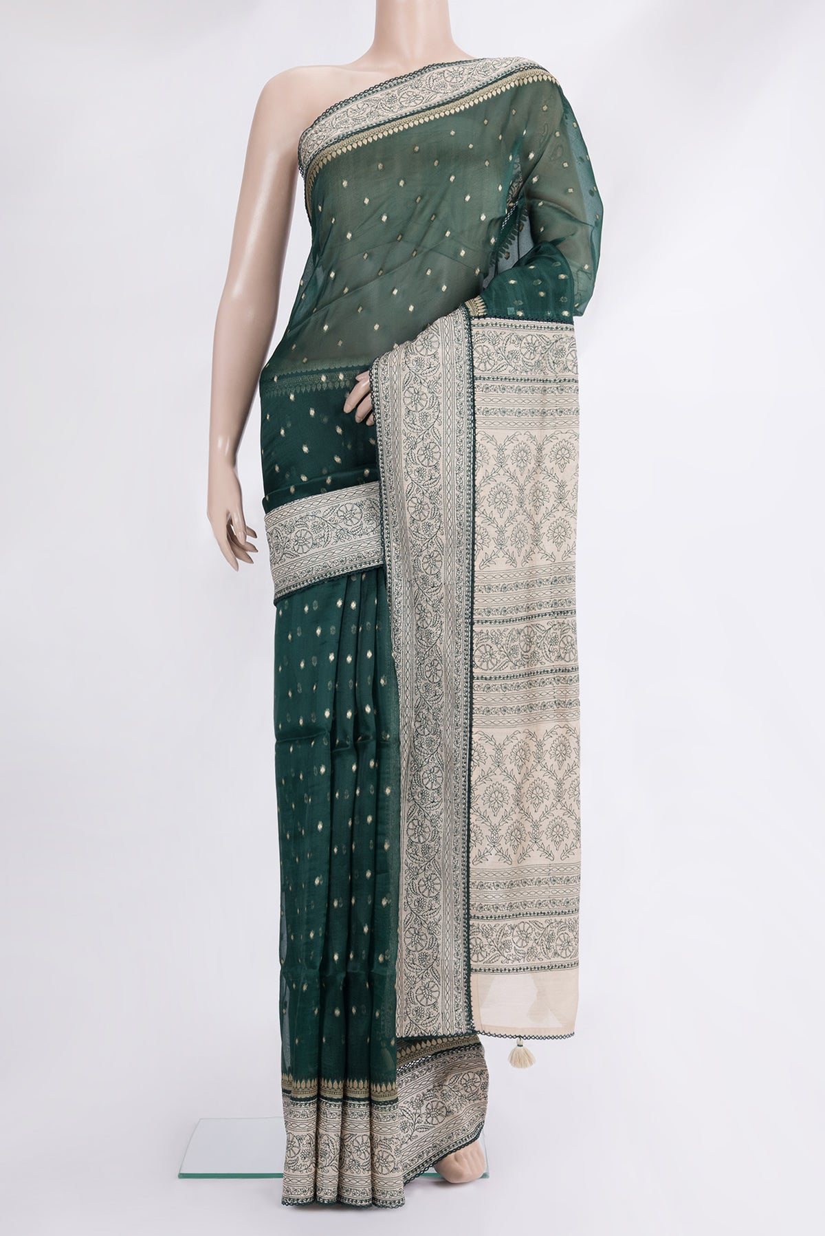 Bottle Green Organza Saree with Zari Butta on the body and Embroidered Border.  displayed on a mannequin