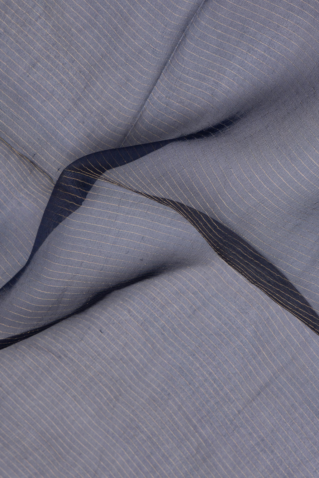 Close up of Pure Silk Navy Blue Dual Tone Tussar Saree with Stripes on the body and Embroidery Border.  displaying folds