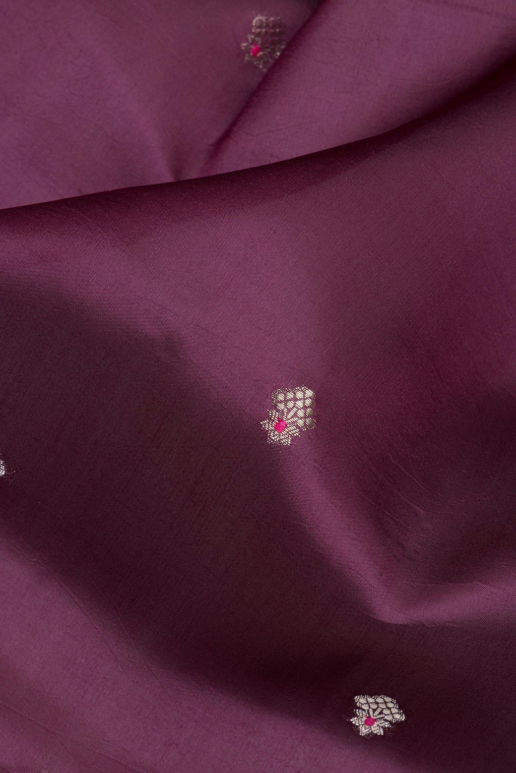 Close up of Pure Silk Burgundy Dual Tone Tussar Saree with Zari Butta on the body and Fancy Border.  displaying folds